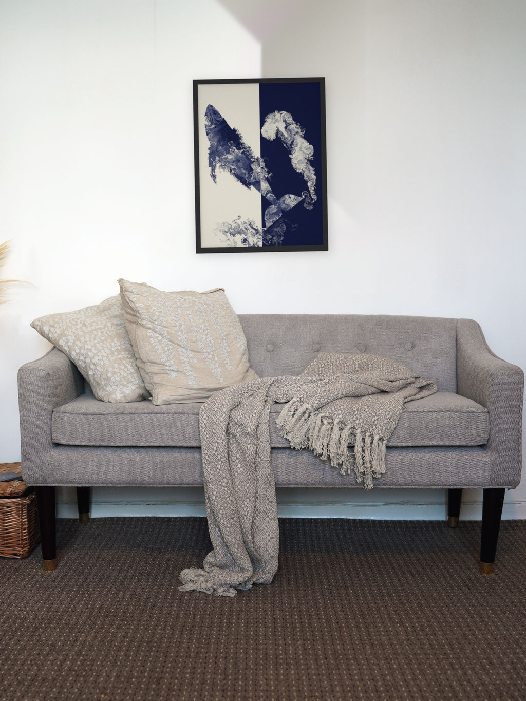 Coming Up for Air humpback whale art print, cream and indigo ocean wall art, shown above a living room sofa