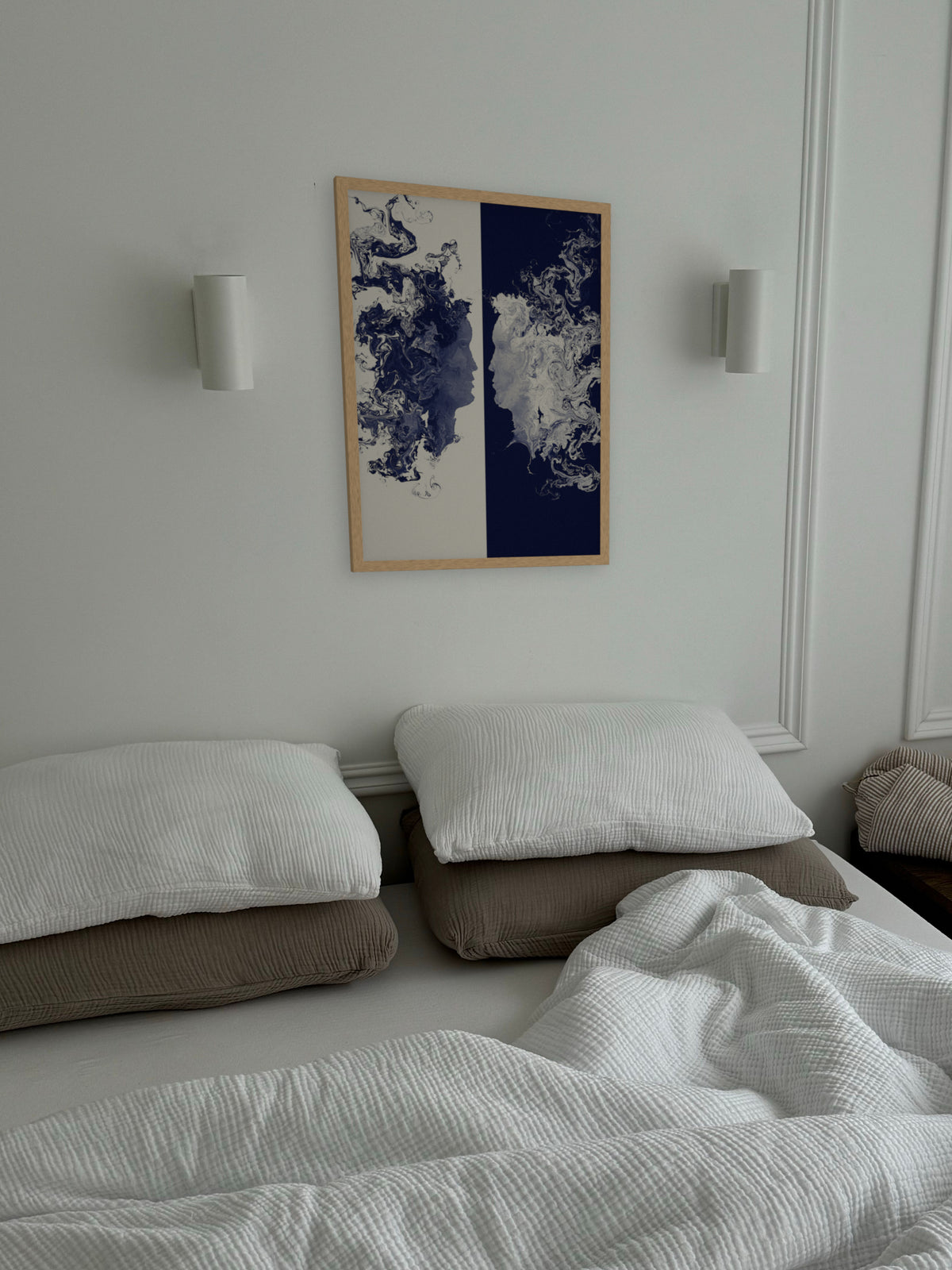 The Space Between two faces art print, cream and indigo romantic wall art, shown in a bedroom