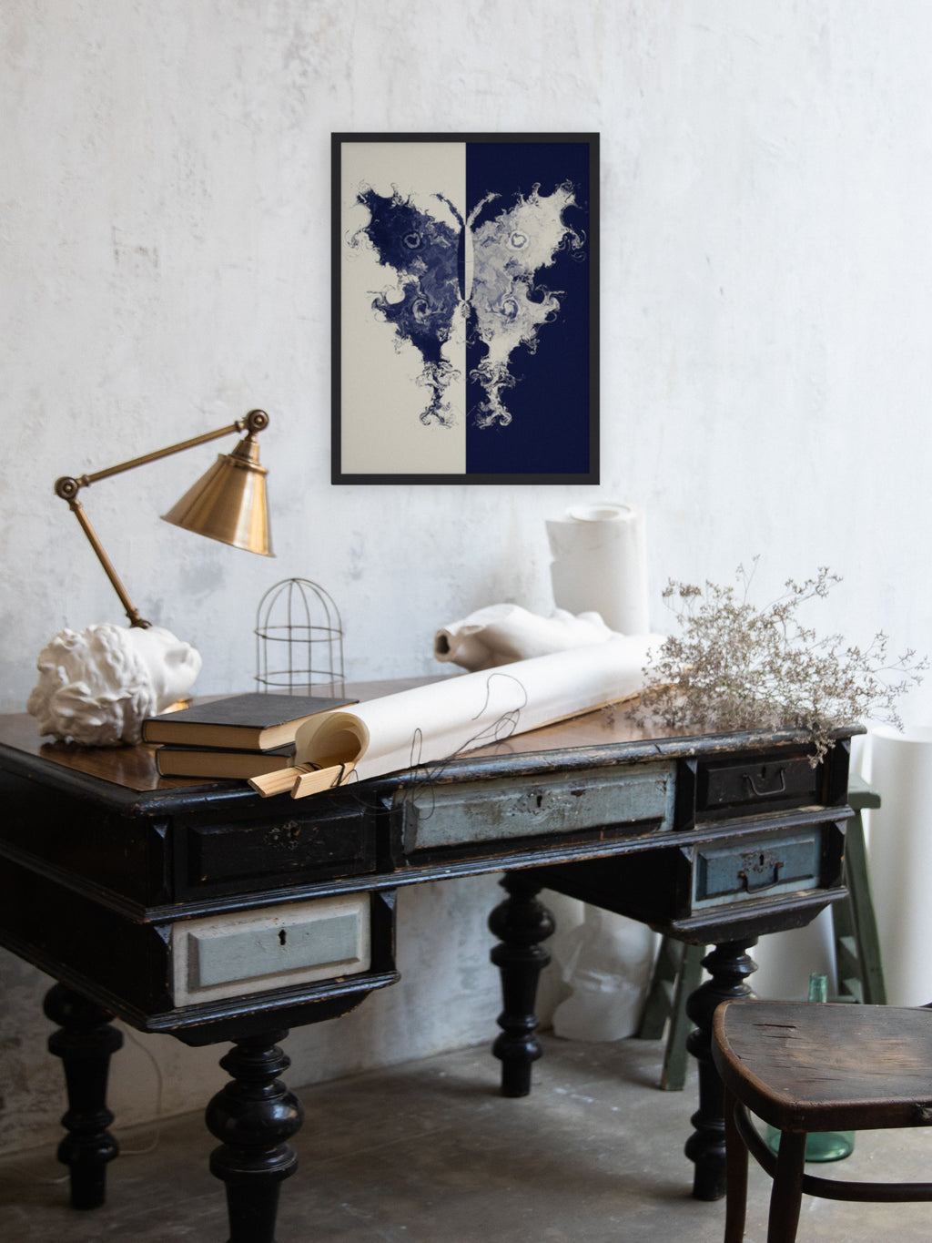 The Fold moth ink blot art print, cream and indigo study wall art, shown above a writing desk