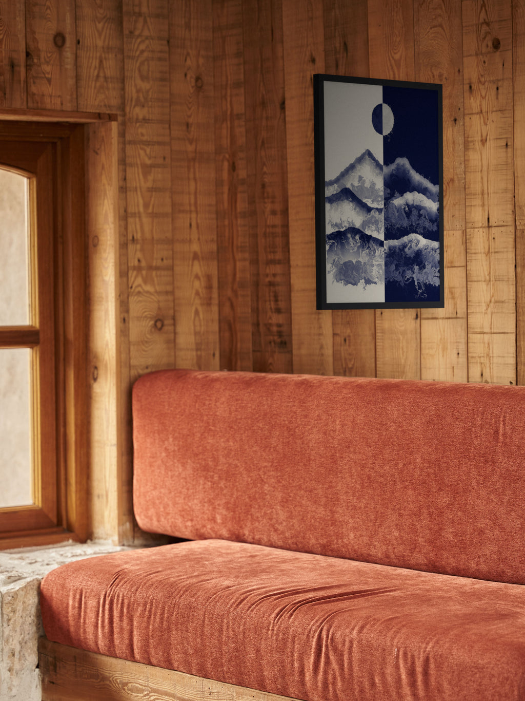 Two Skies mountain sun and moon art print, cream and indigo landscape wall art, shown in a cabin