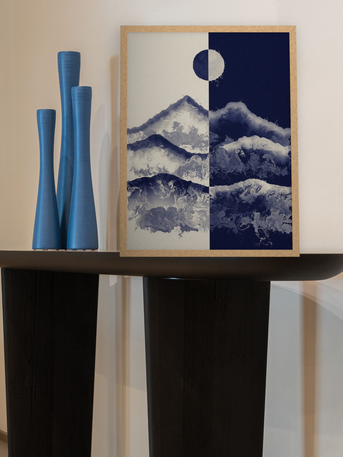 Two Skies mountain sun and moon art print, cream and indigo landscape wall art, leaning on a console