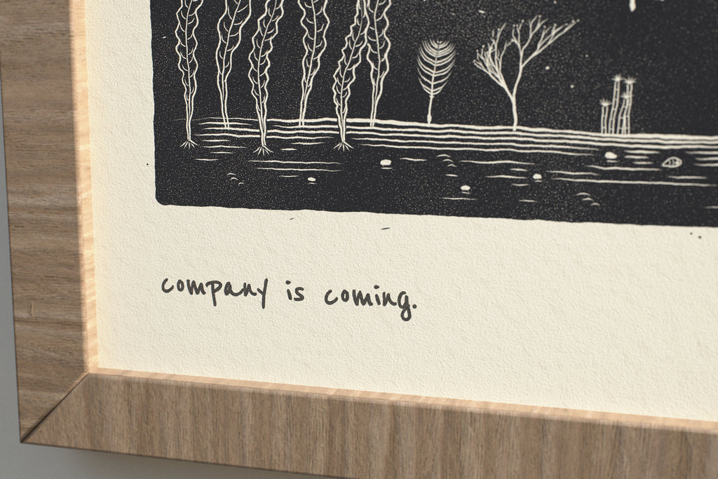 Close-up of the matte archival paper and handwritten caption on the Company Is Coming whale print