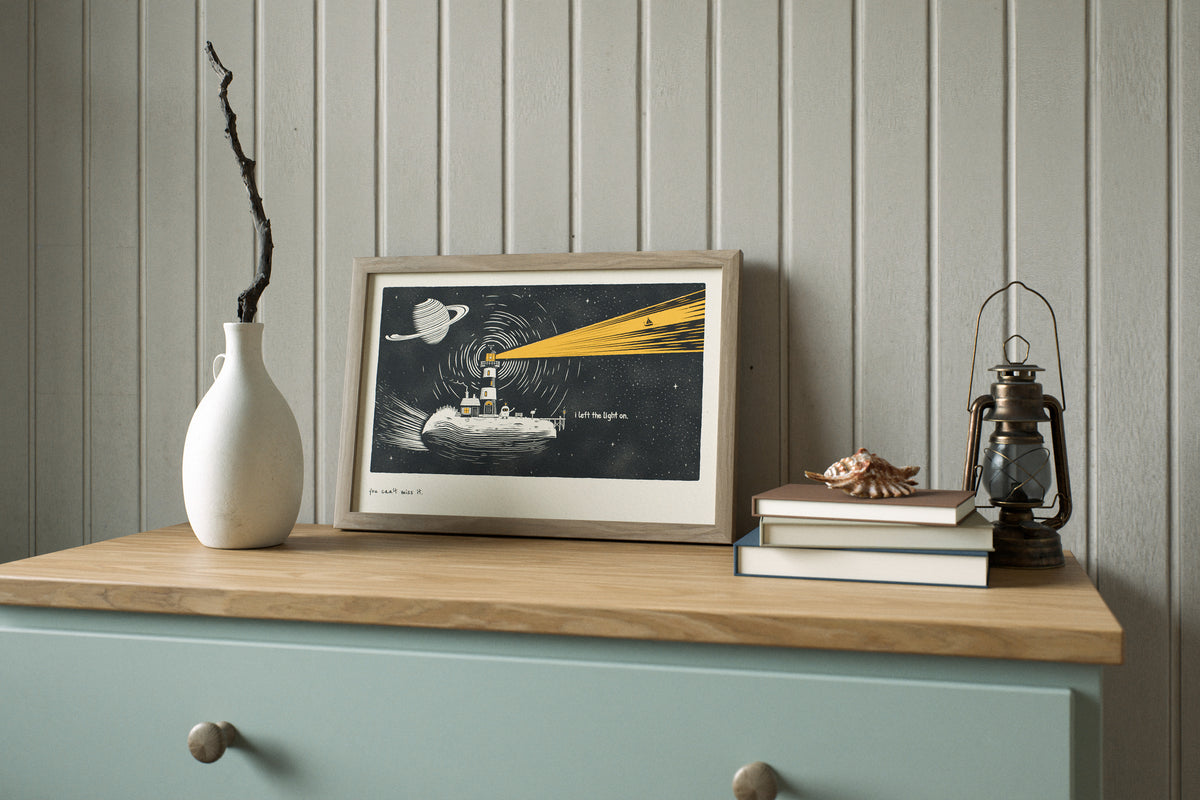 Nautical lighthouse print in 12x18 on the wall of a coastal cottage in daylight